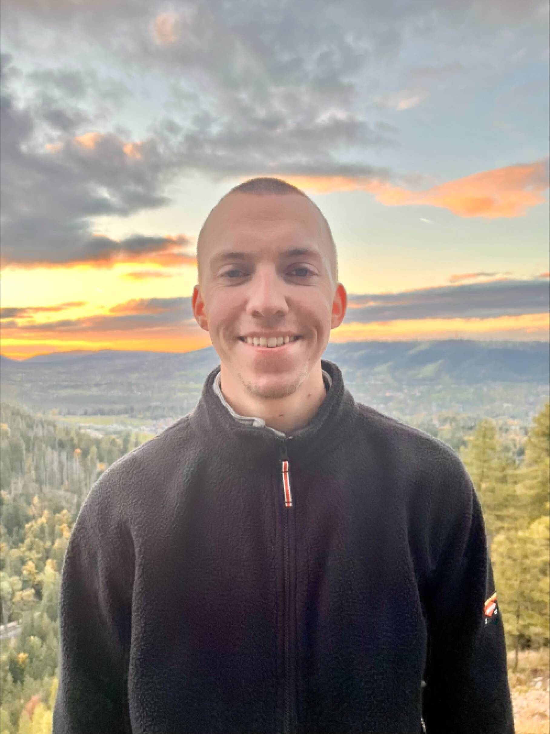 Steve posing in front of a sunset